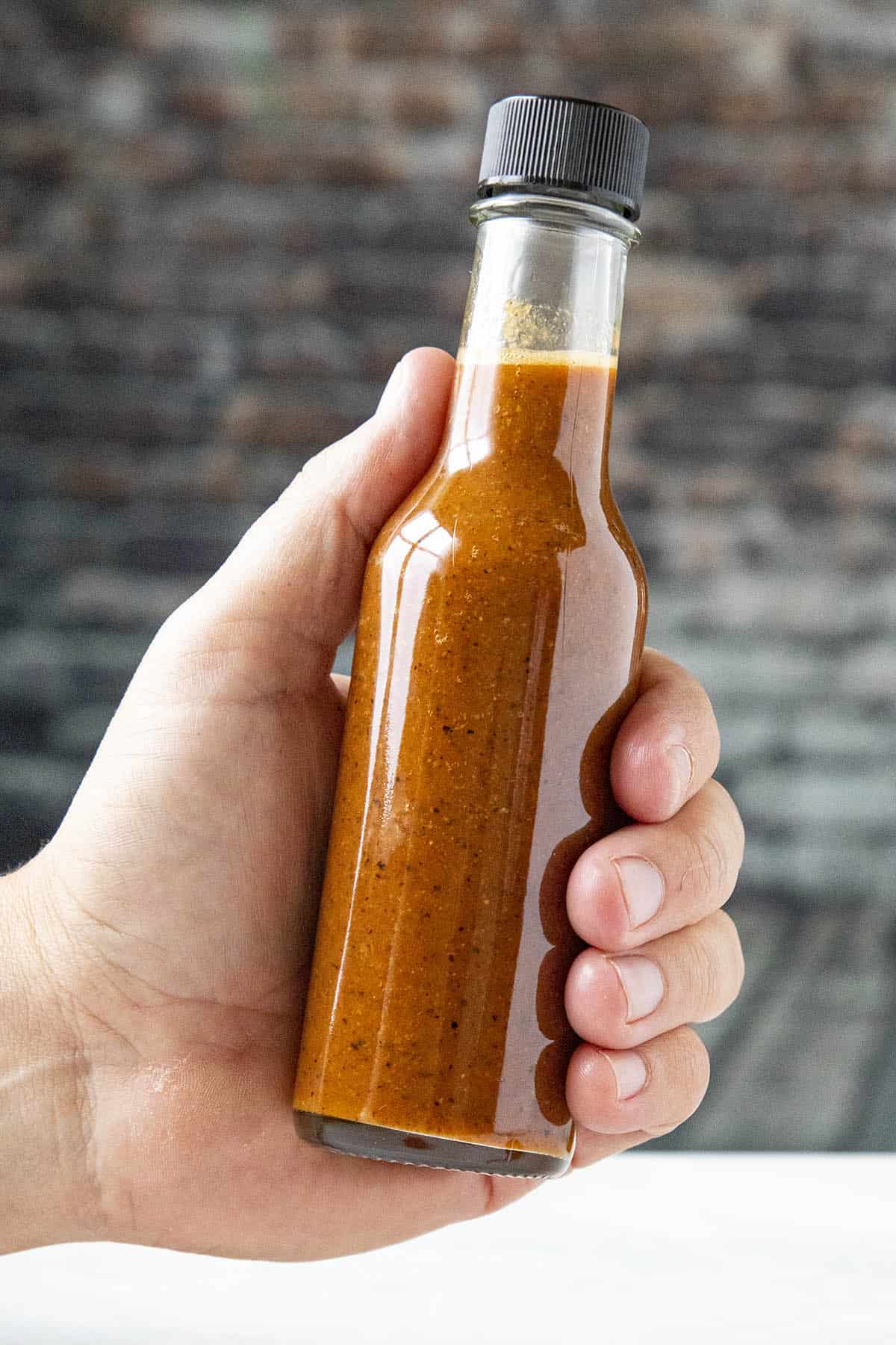 A bottle of Carolina Reaper Hot Sauce in my hand, ready to spice things up!