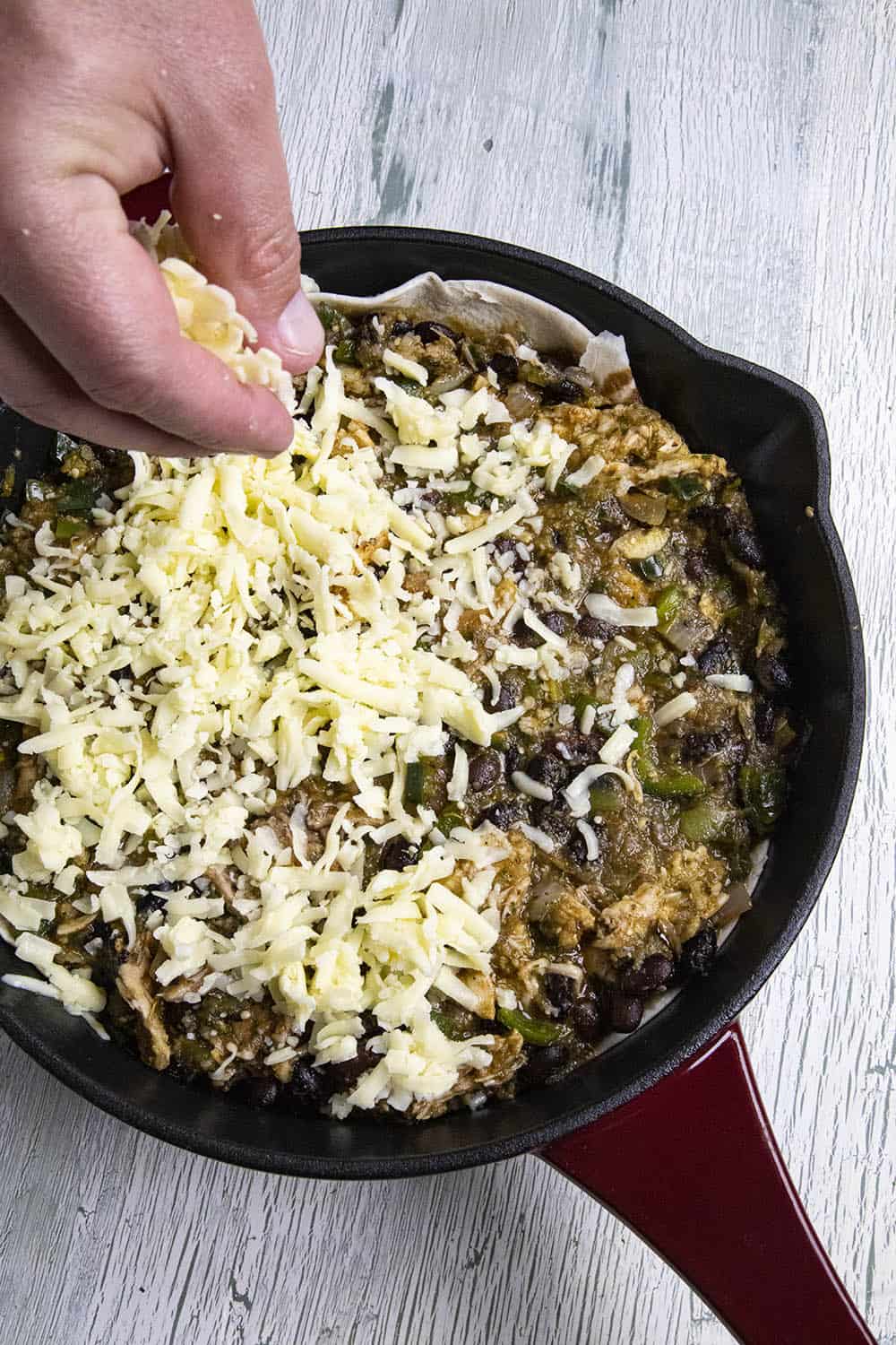 Top the casserole filling with shredded cheese