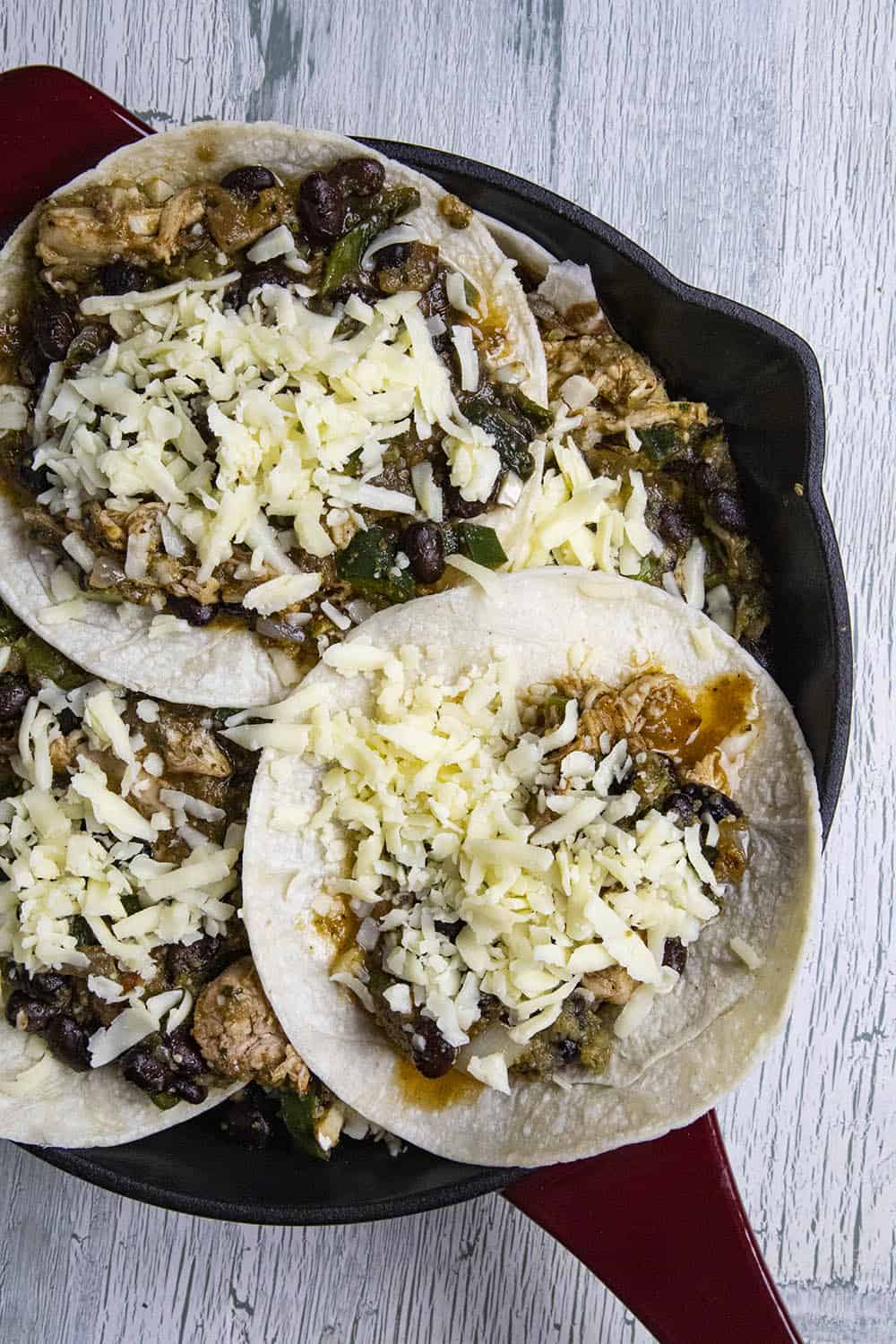 Topping the casserole with extra filling and shredded cheese