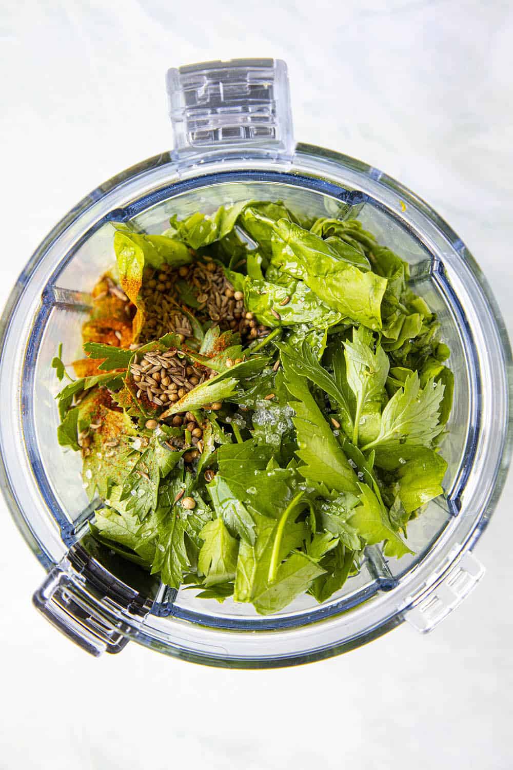 Green Harissa ingredients in a food processor, ready to process