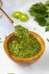 Green Harissa served in a wooden bowl