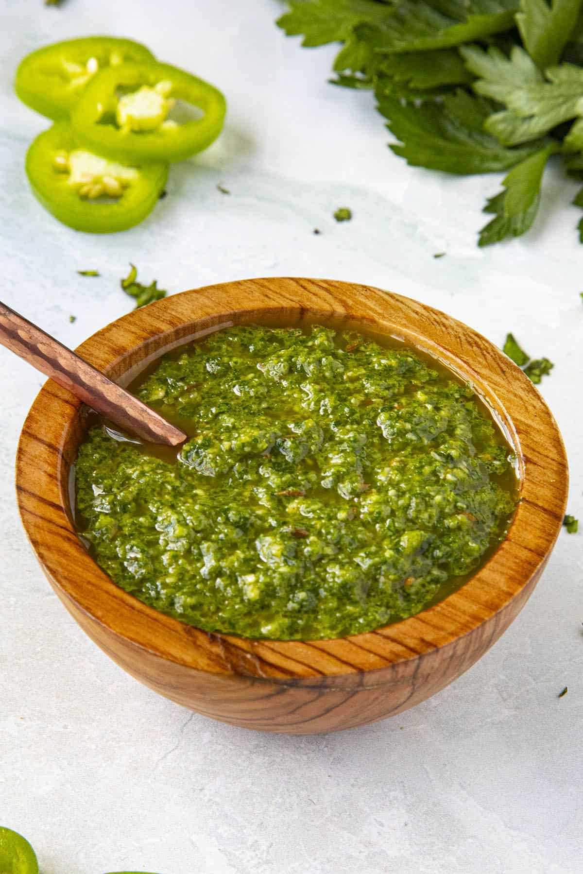 Green Harissa in a bowl with a serving spoon