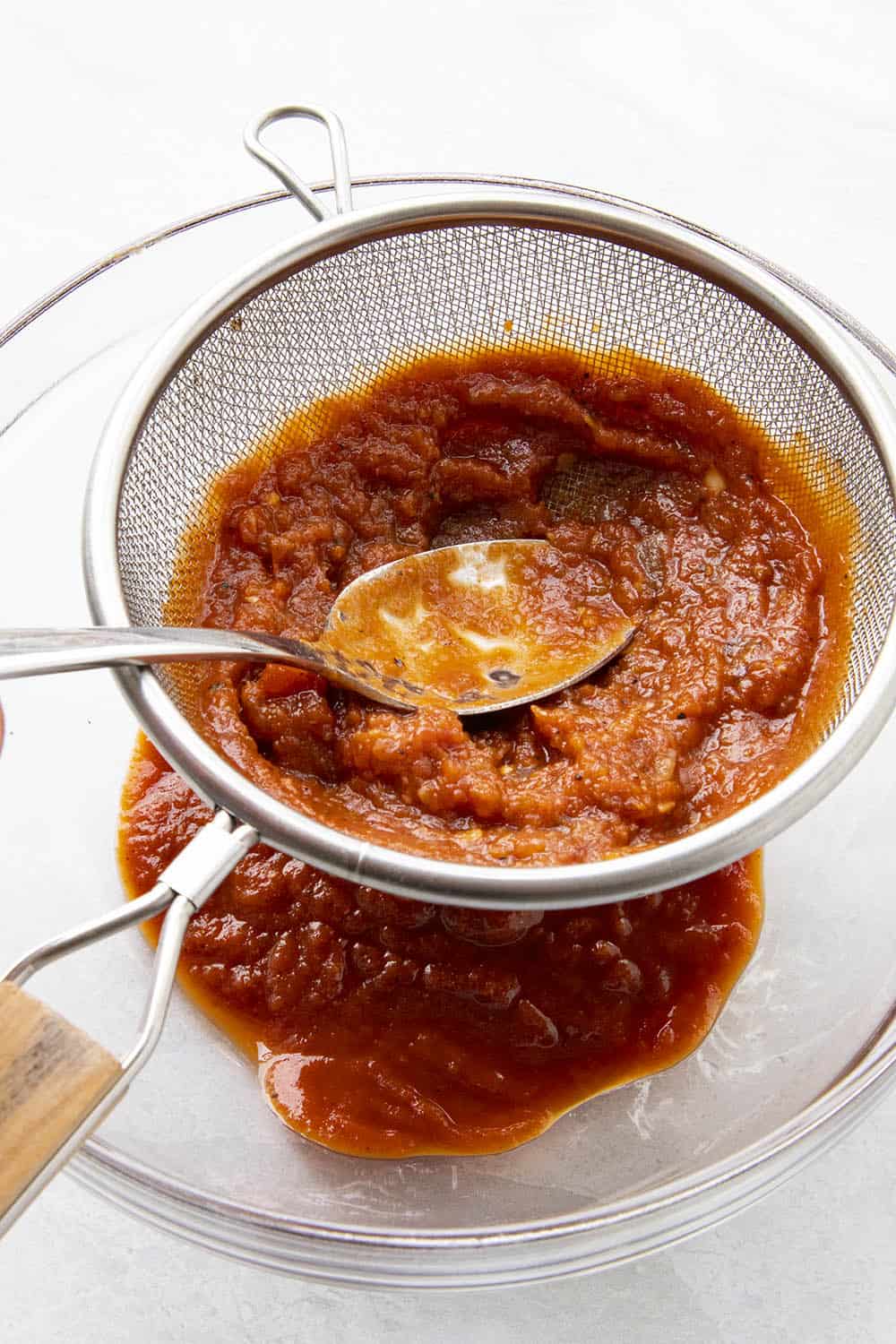 Straining the homemade ketchup