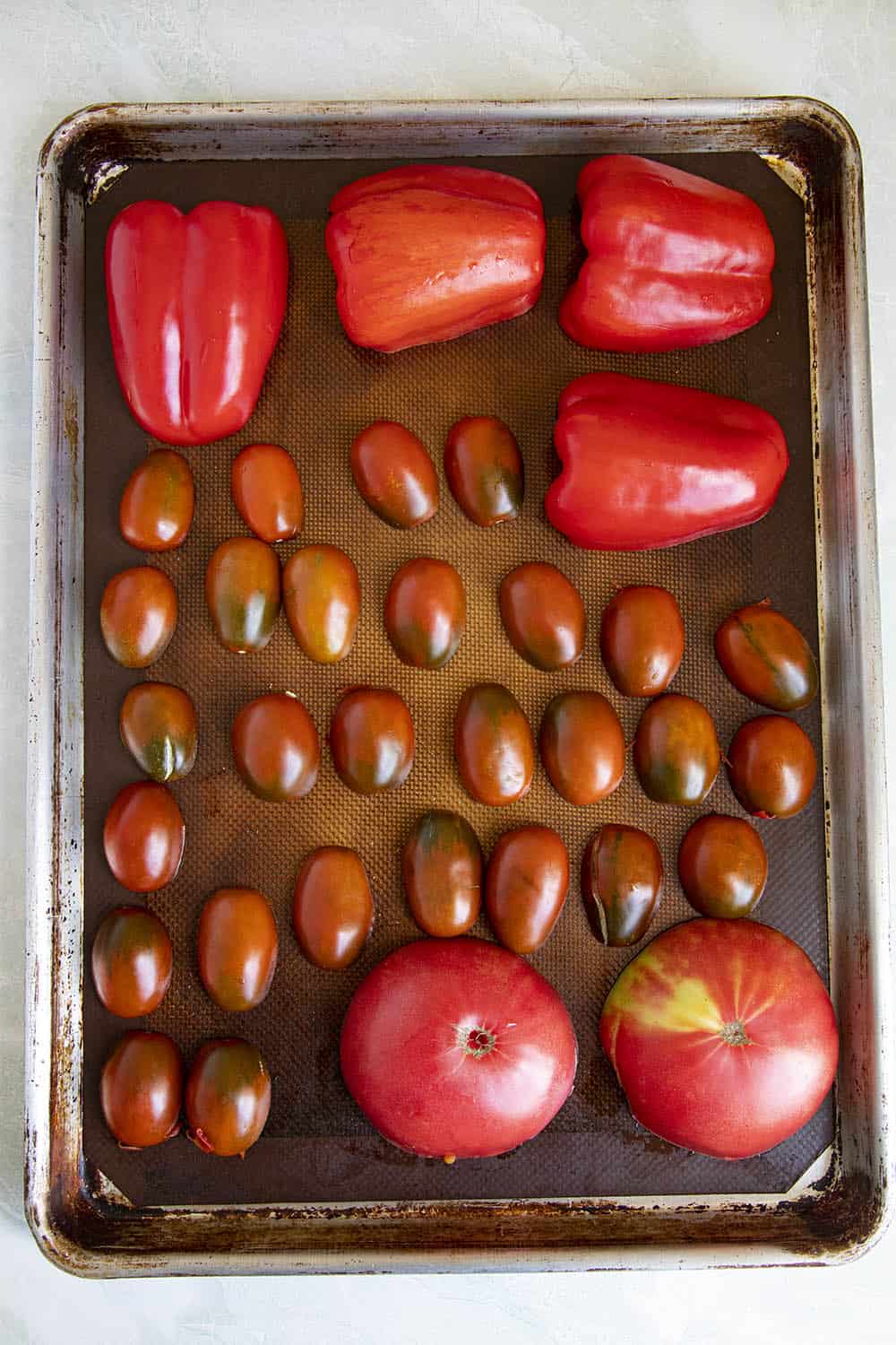 Tomatoes and peppers ready for roasting