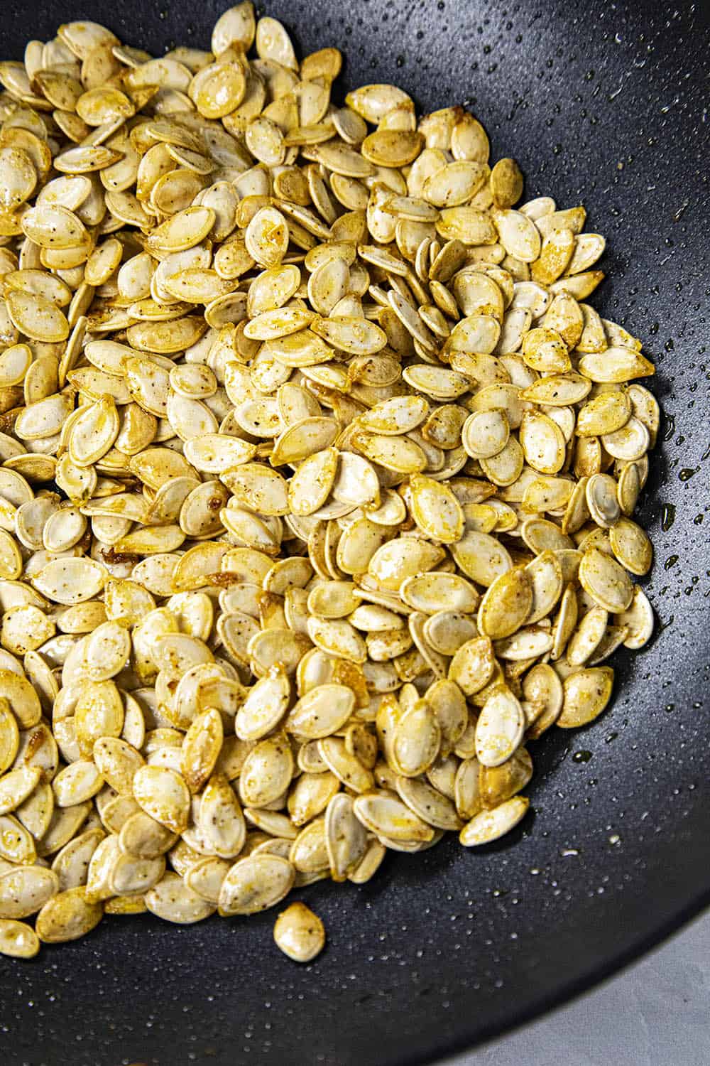 Pumpkin seeds in a pan for this pumpkin soup recipe