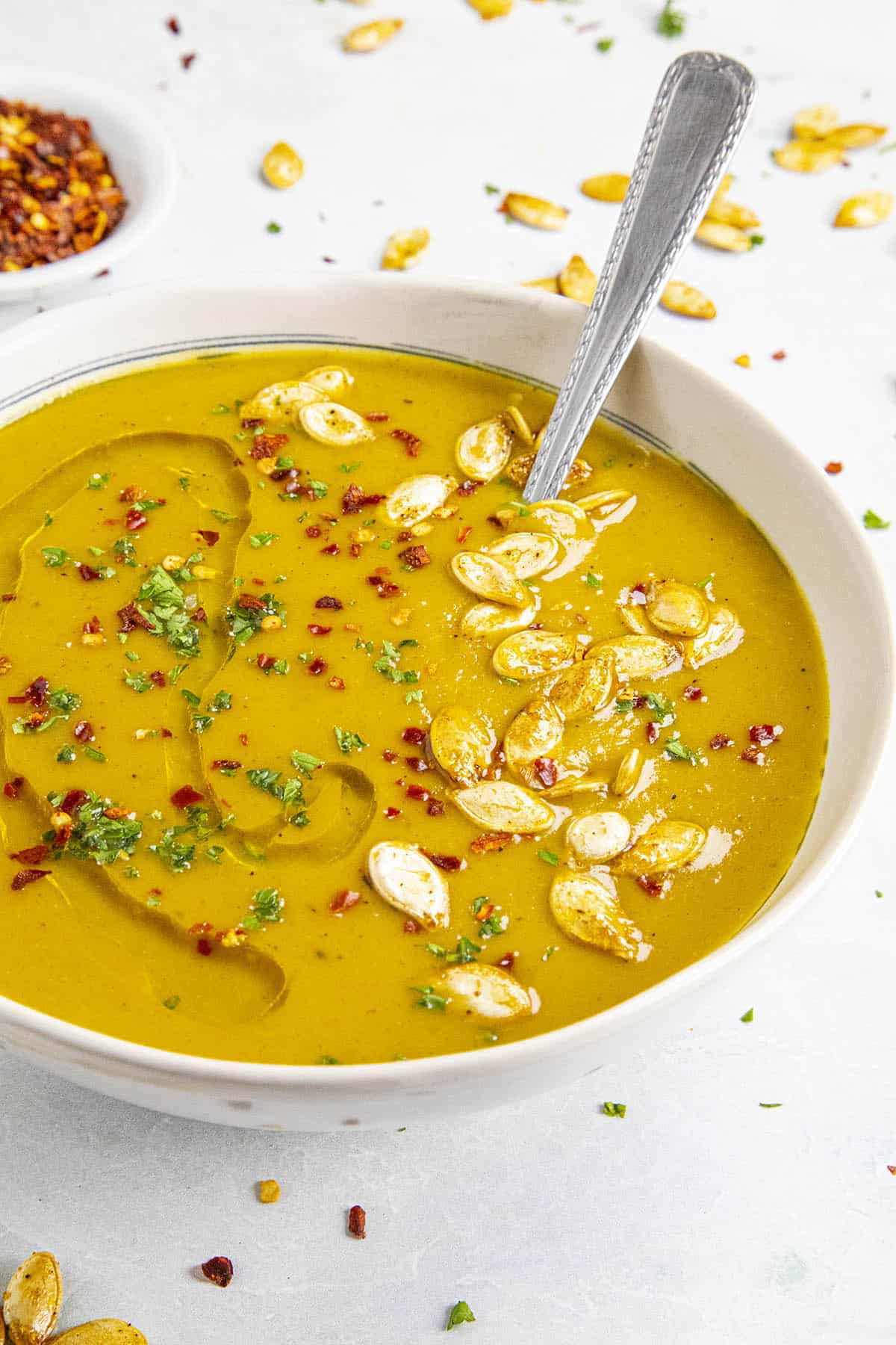 Spicy Pumpkin Soup in a bowl with pumpkin seeds for garnish