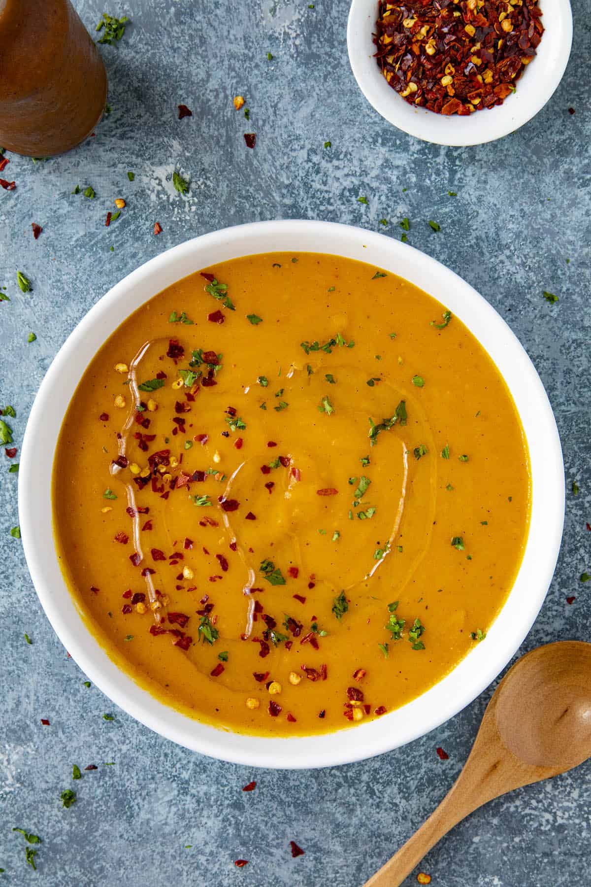 Spicy Cajun-Style Carrot Soup in a bowl with chili flakes and a drizzle of olive oil
