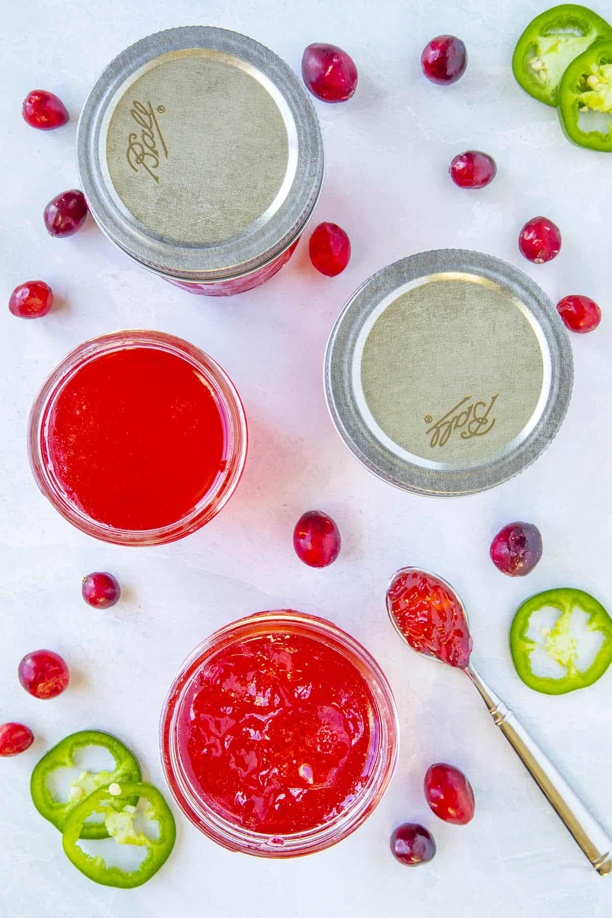 Cranberry Jalapeno Jelly in jars an on a spoon