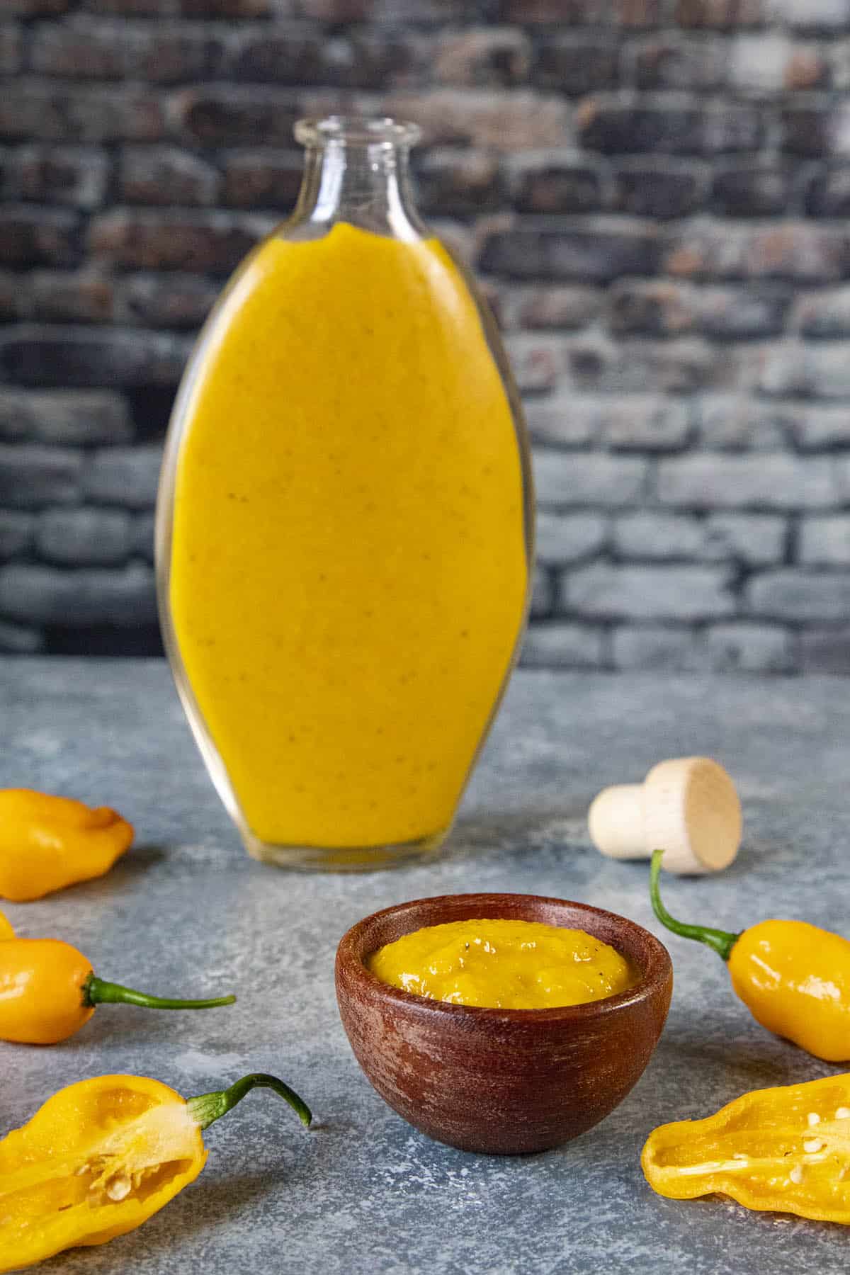 Devils Tongue Hot Sauce in a small glass bottle, very vibrant yellow in color