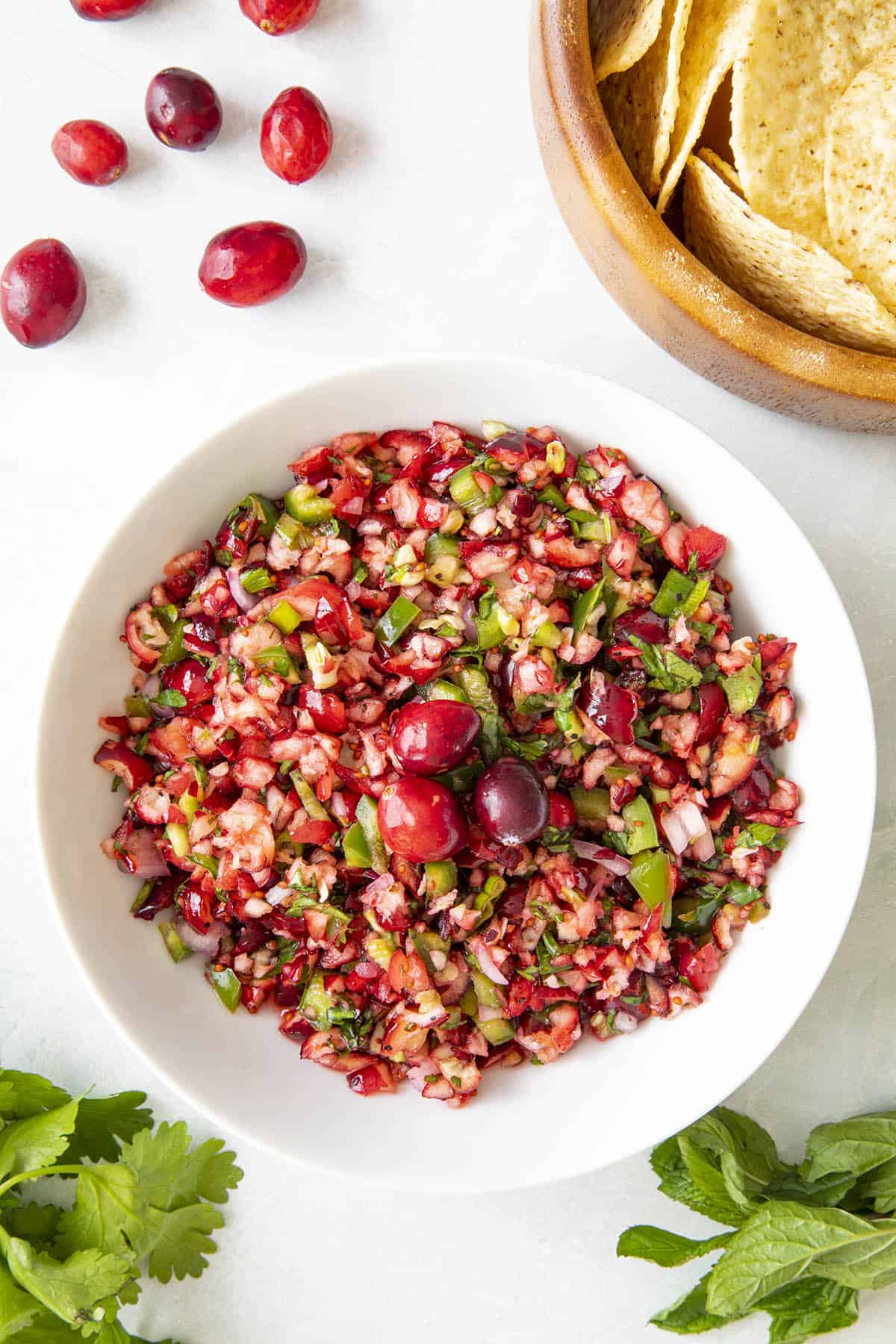 Fresh Cranberry Salsa in a bowl with extra cranberries on top