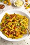 Penne Arrabbiata served in a white bowl