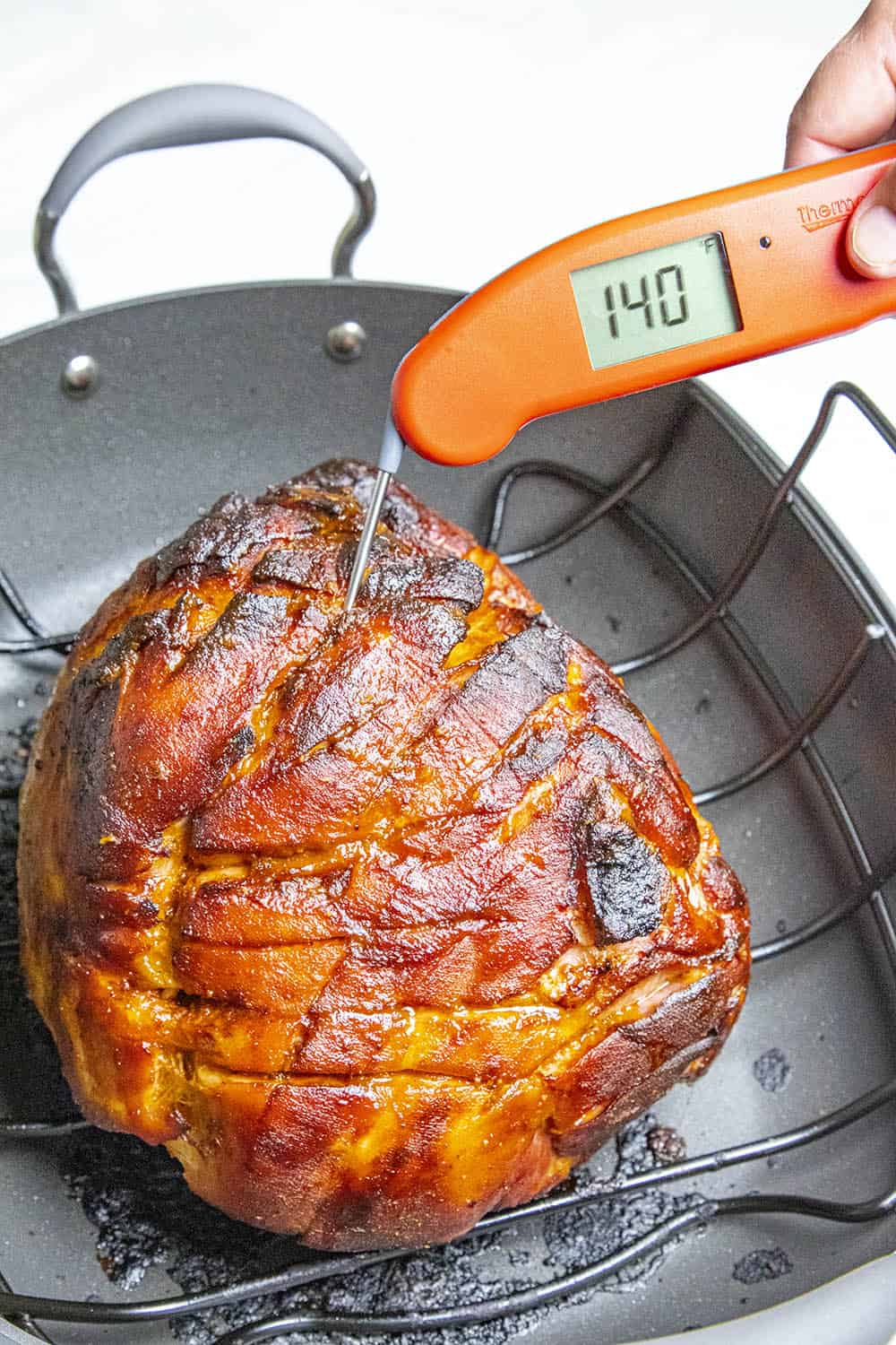 Measuring the internal temperature of the baked ham - 140 degrees F.