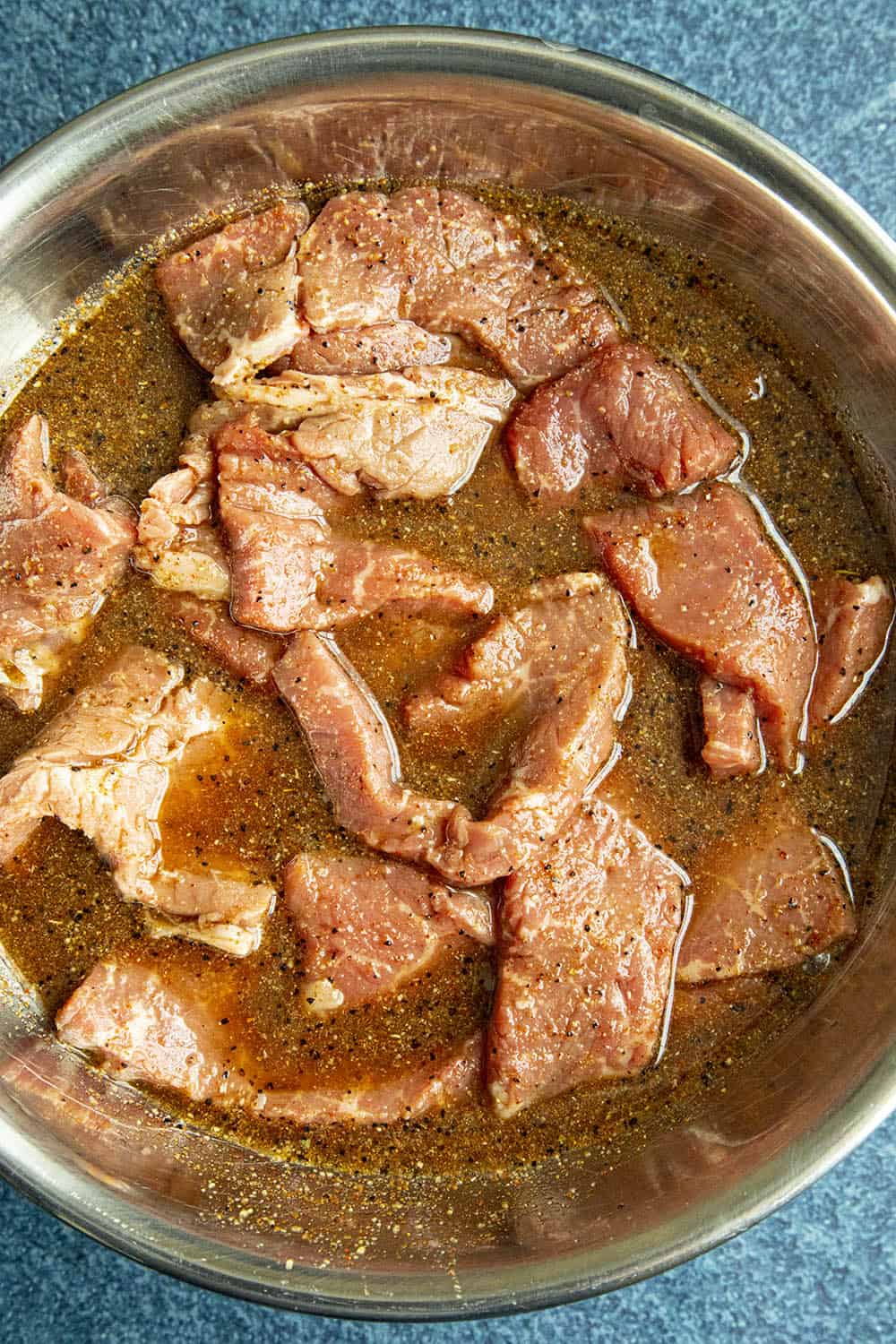 Marinating the beef strips to make spicy beef jerky