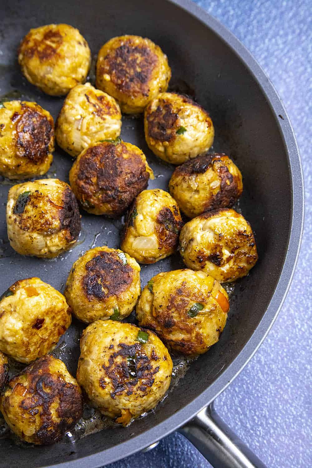 Buffalo Chicken Meatballs in a pan, ready for Buffalo Sauce