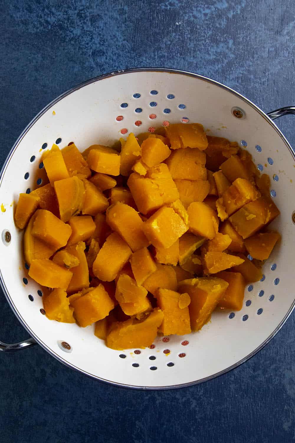 Boiled sweet potatoes in a collander