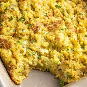A scoop of Cornbread Dressing missing from the casserole dish