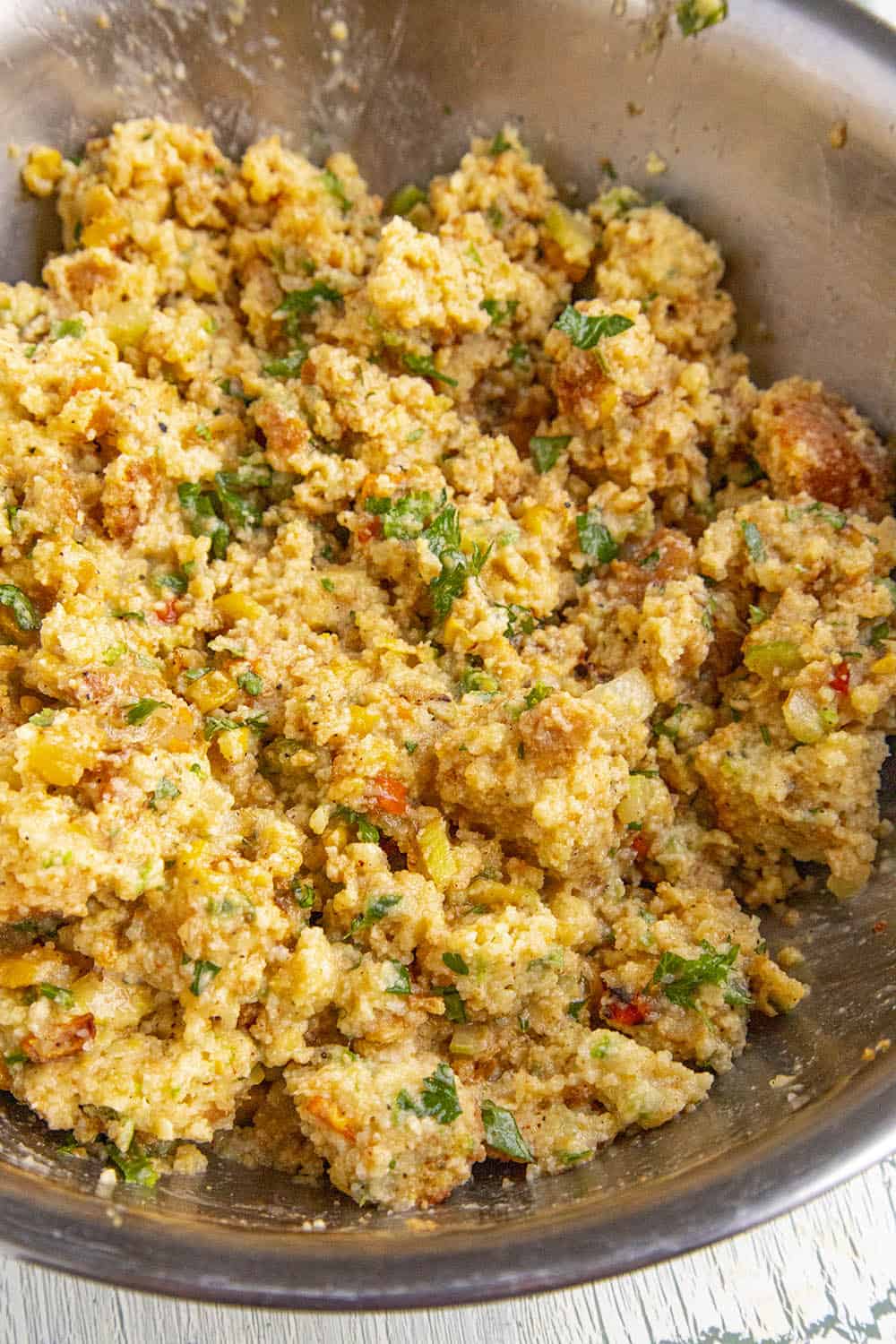 Cornbread Dressing with the wet ingredients, mixed in a bowl