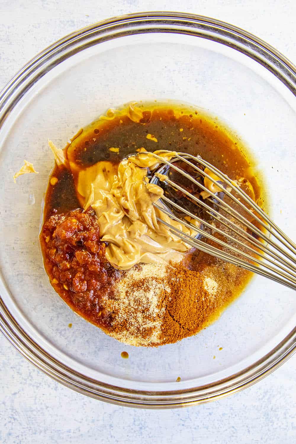Ingredients in a bowl to make Easy Thai Peanut Sauce, ready to whisk
