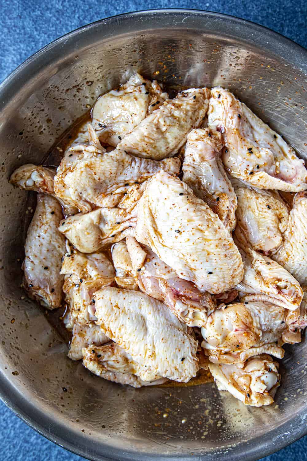 Marinating the chicken wings in a bowl with my grilled chicken marinade.