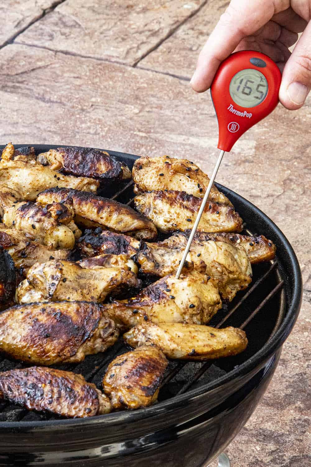 Checking the temperature of my grilled chicken wings.