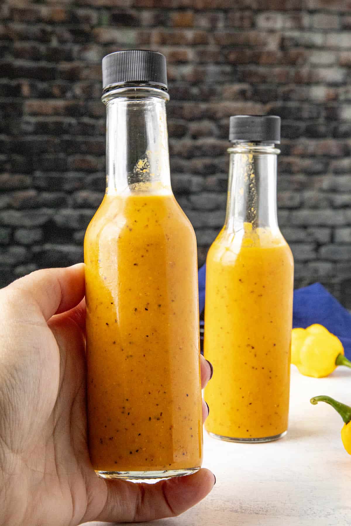 Holding a bottle of Scotch Bonnet Curry Hot Sauce