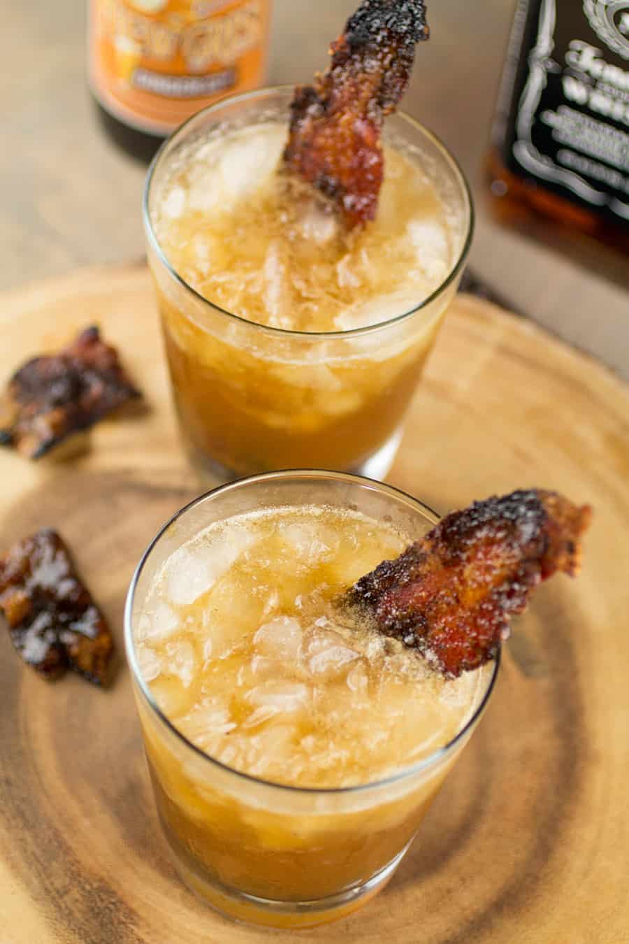 Smoky Whiskey Mule Cocktail in two glasses with candied bacon
