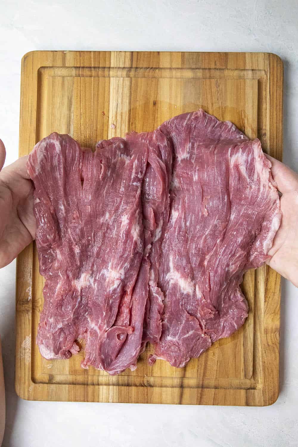 Folding open the butterflied flank steak like a book