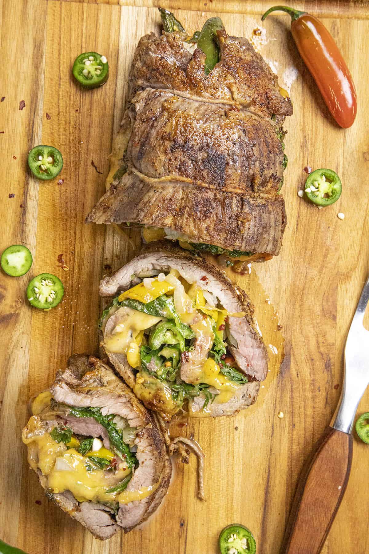 Spinach, Cheese and Chili Stuffed Flank Steak on a cutting board