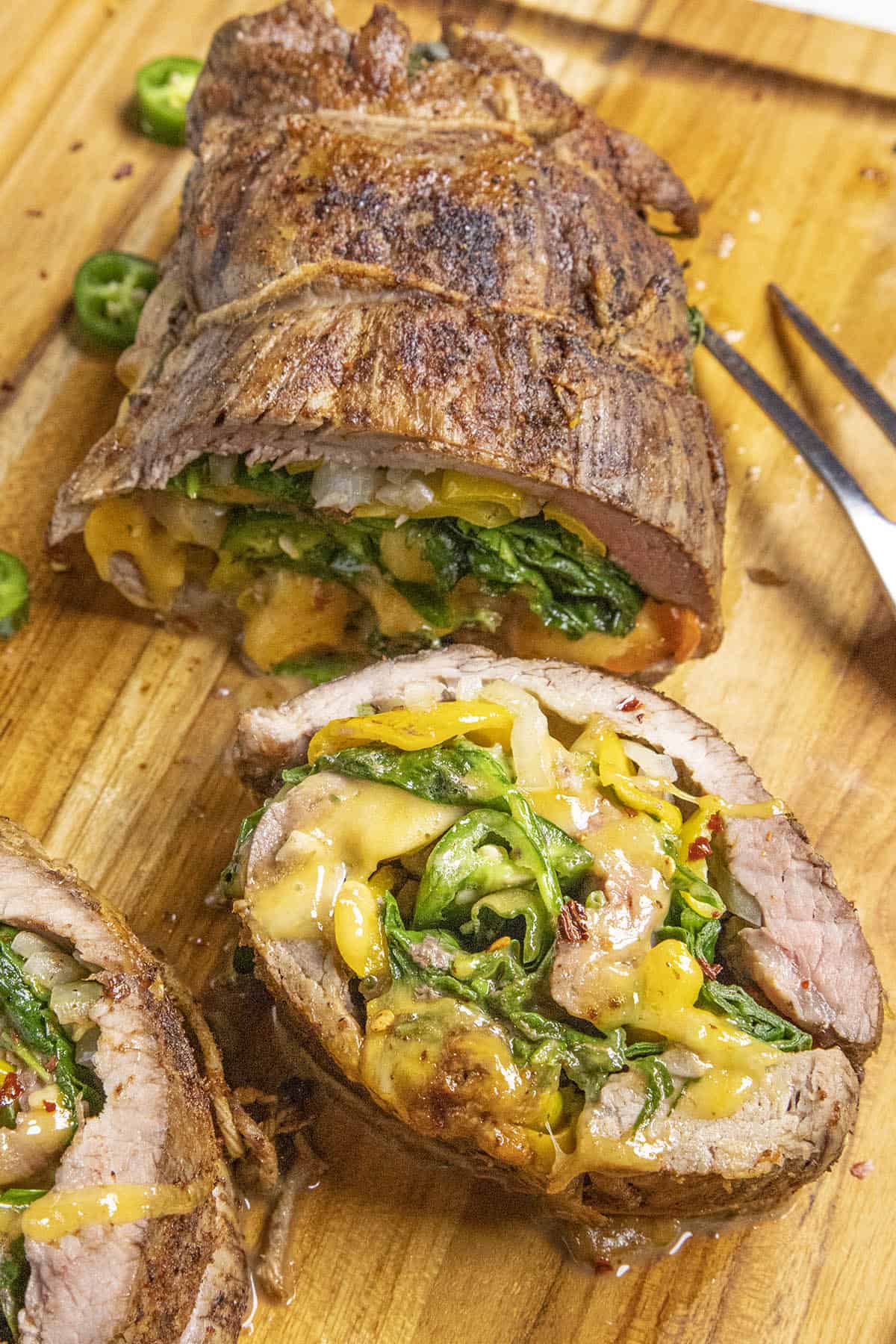 A large slice of Spinach, Cheese and Chili Stuffed Flank Steak