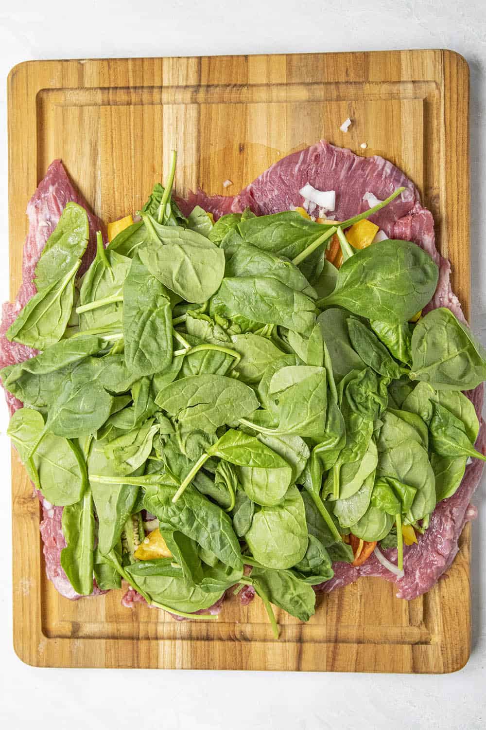 Adding spinach to the flank steak