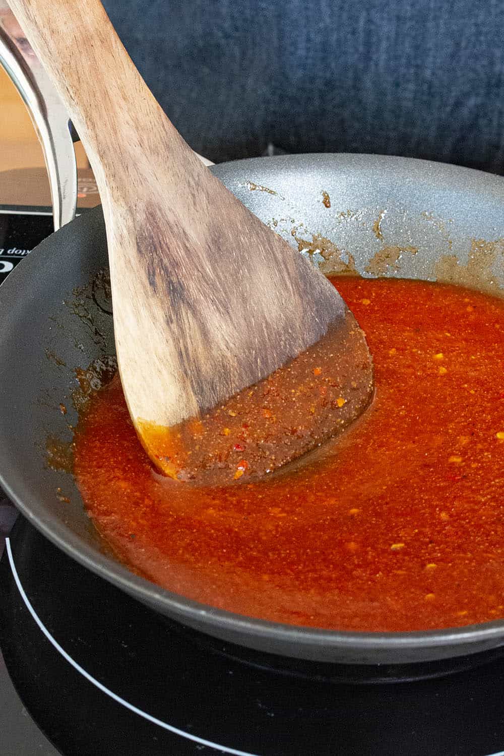 Making the honey sriracha glaze in a pan