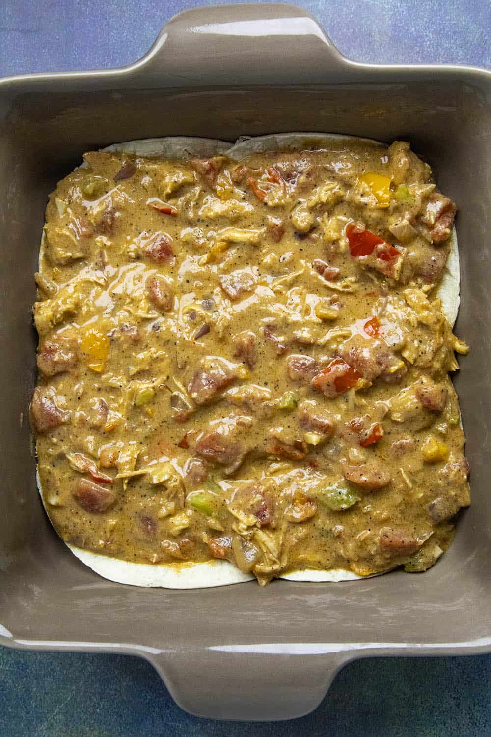 Layering in the filling of the King Ranch Casserole.