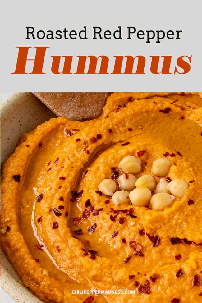 Roasted Red Pepper Hummus - This homemade roasted red pepper hummus recipe is smooth and creamy and so much better when made from scratch. Great for game day, holidays or an anytime snack. Don\'t forget the pitas! #appetizer #hummus #chickpeas #roastedredpeppers