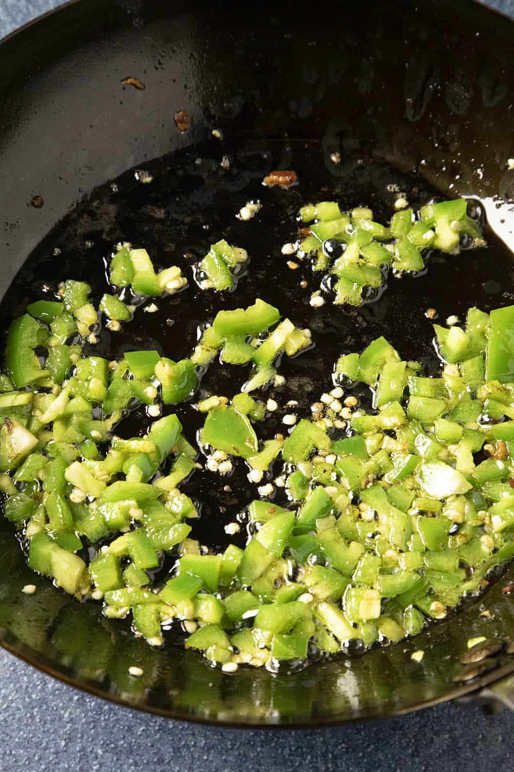 Cooking the jalapeno peppers in a pan