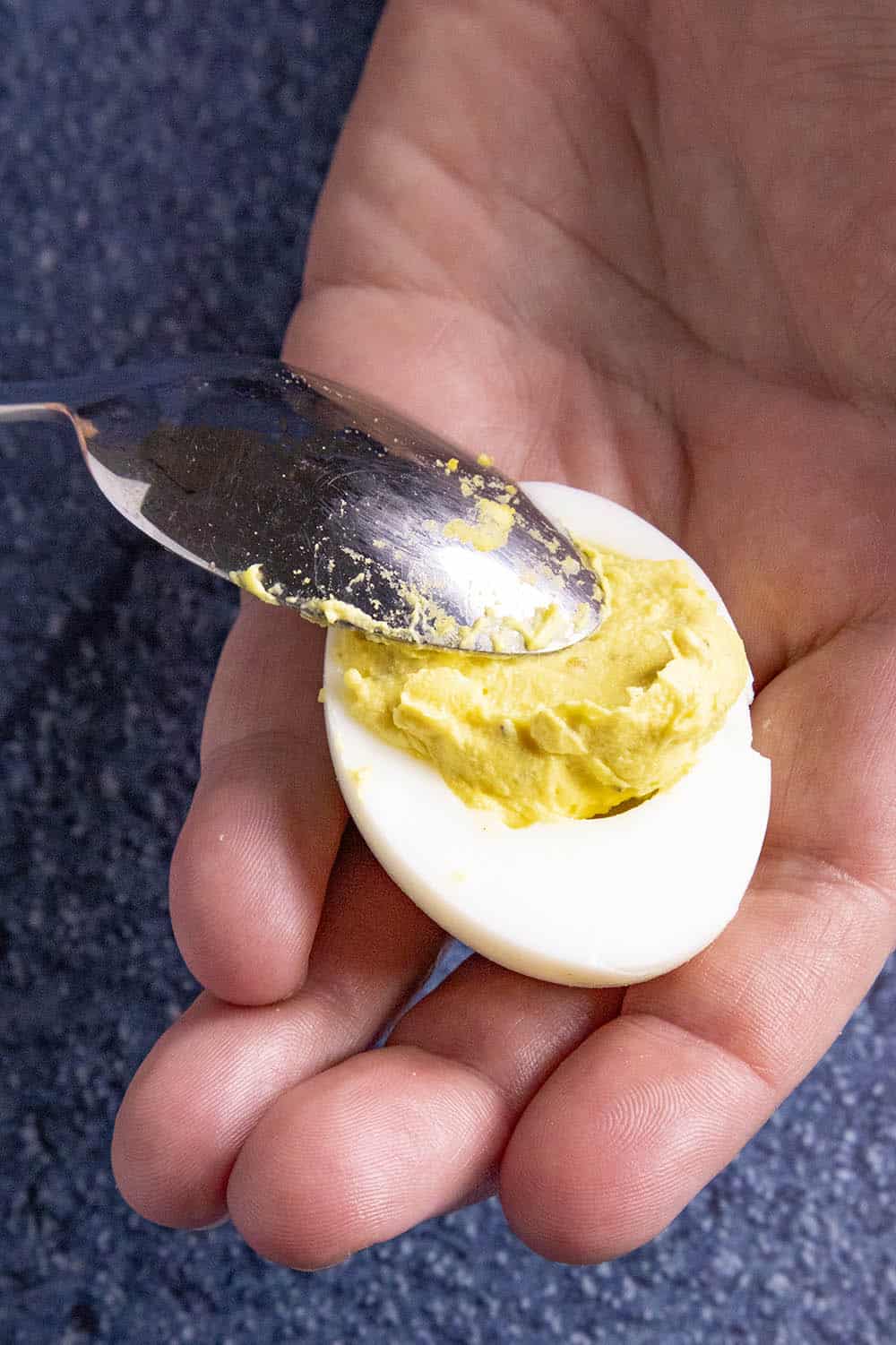 Filling the egg halves with the creamy egg yolk mixture