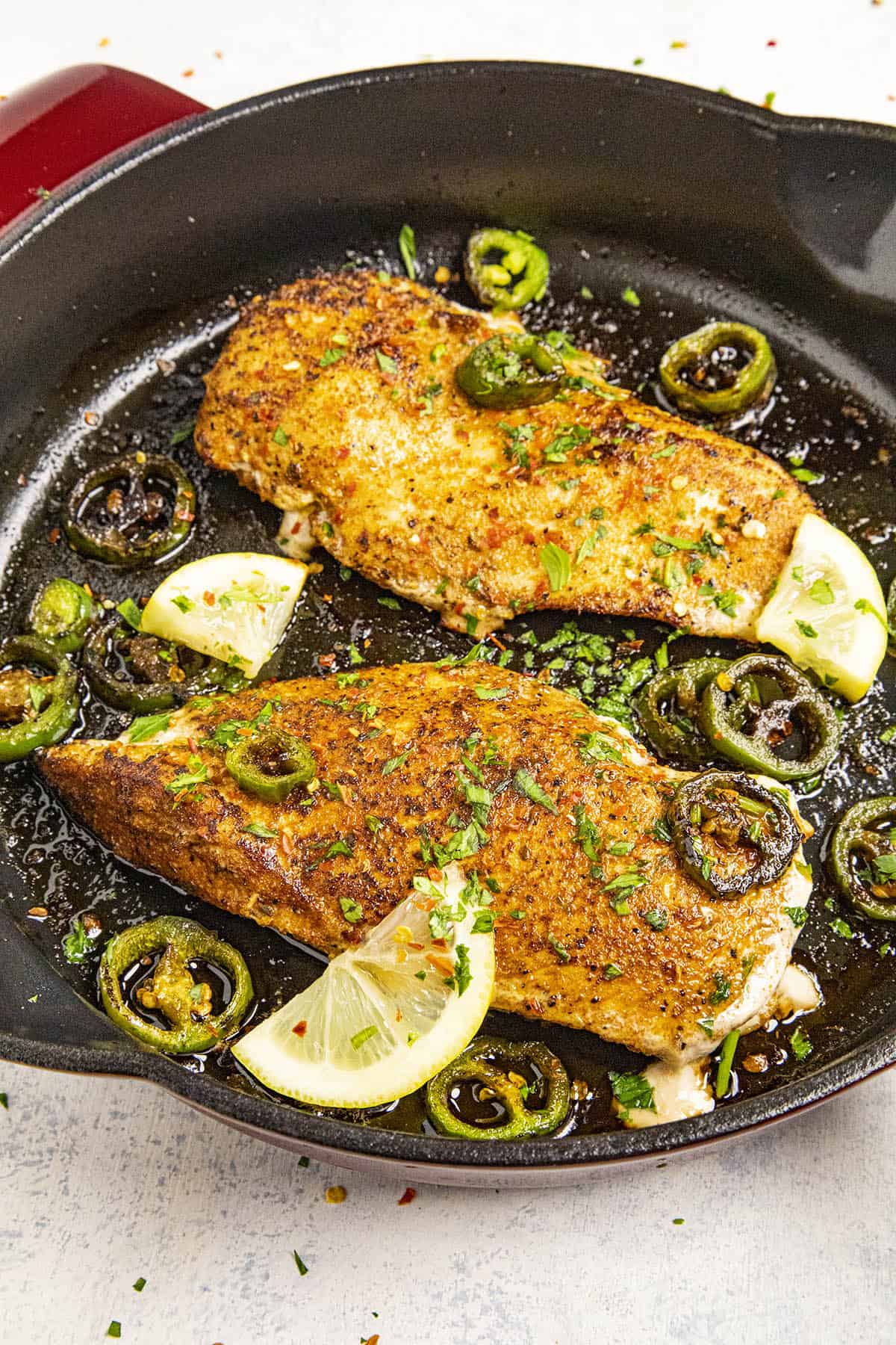 Two Blackened Chicken breasts in a pan