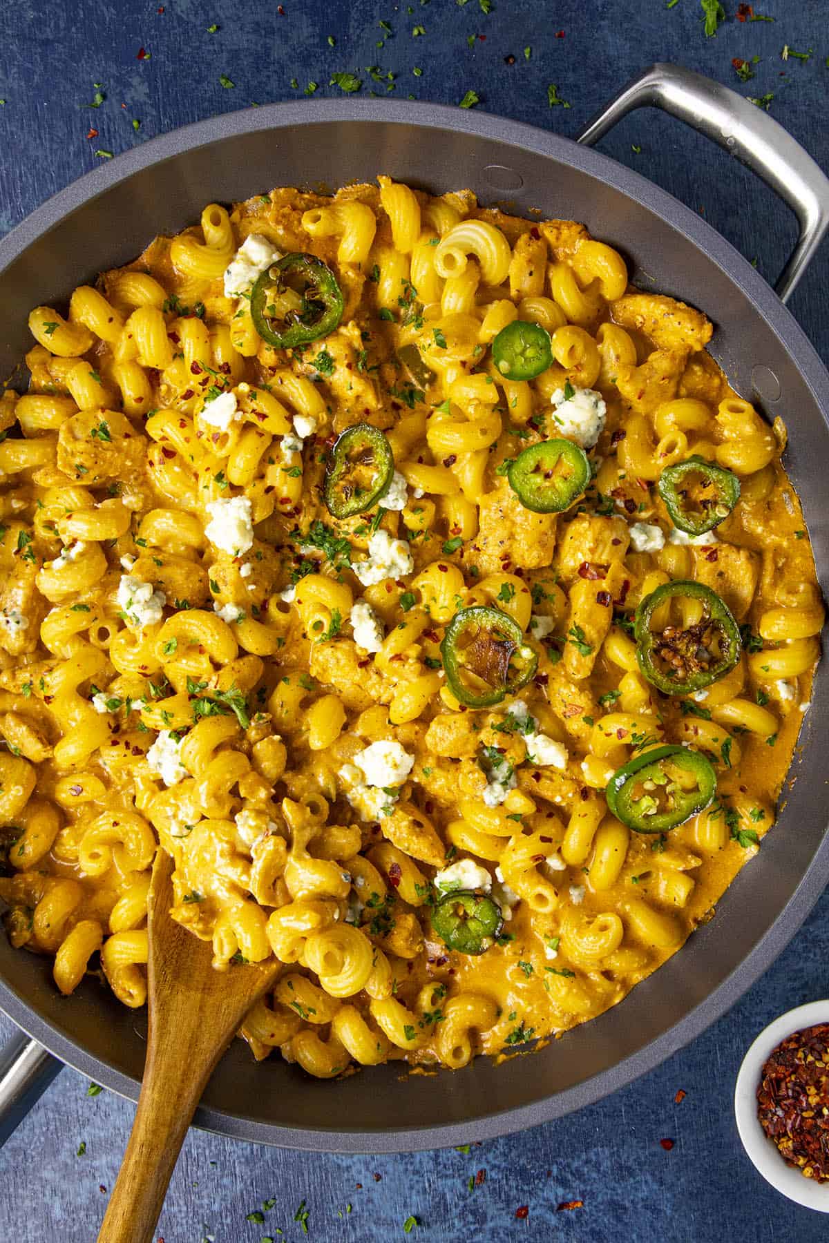 Buffalo Chicken Pasta in a pan with a serving spoon.