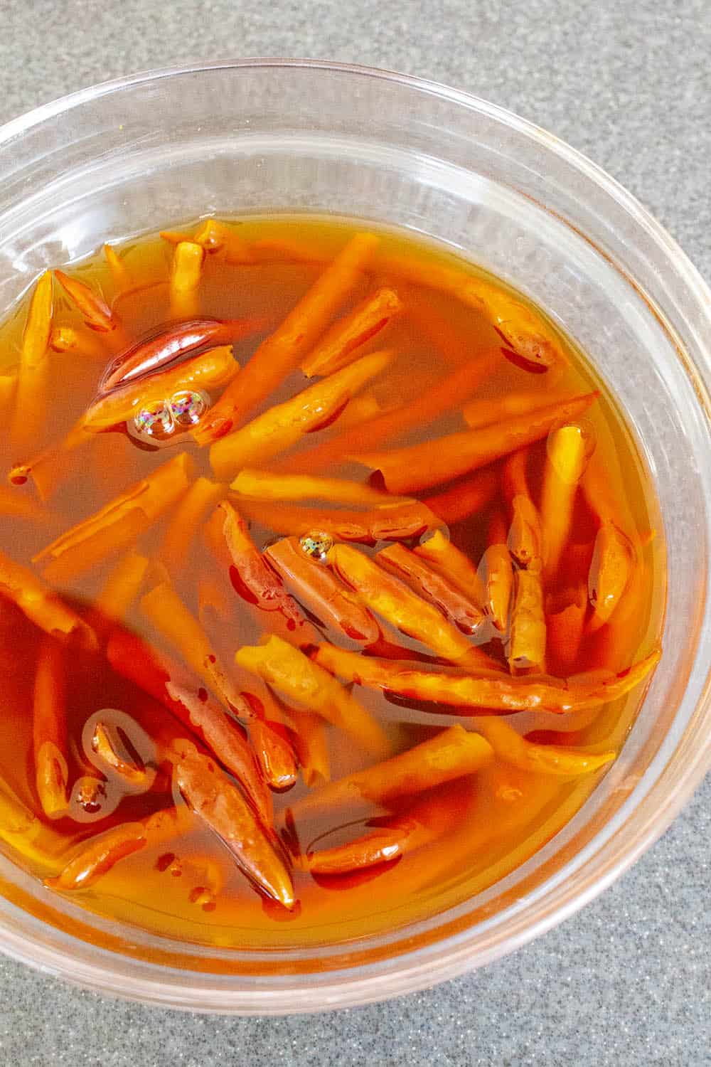 Chile de Arbol peppers soaking in a bowl of water