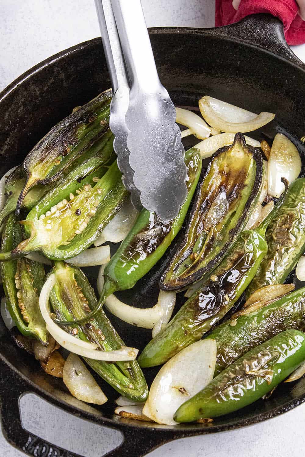 Flipping the blistering chili peppers in a pan