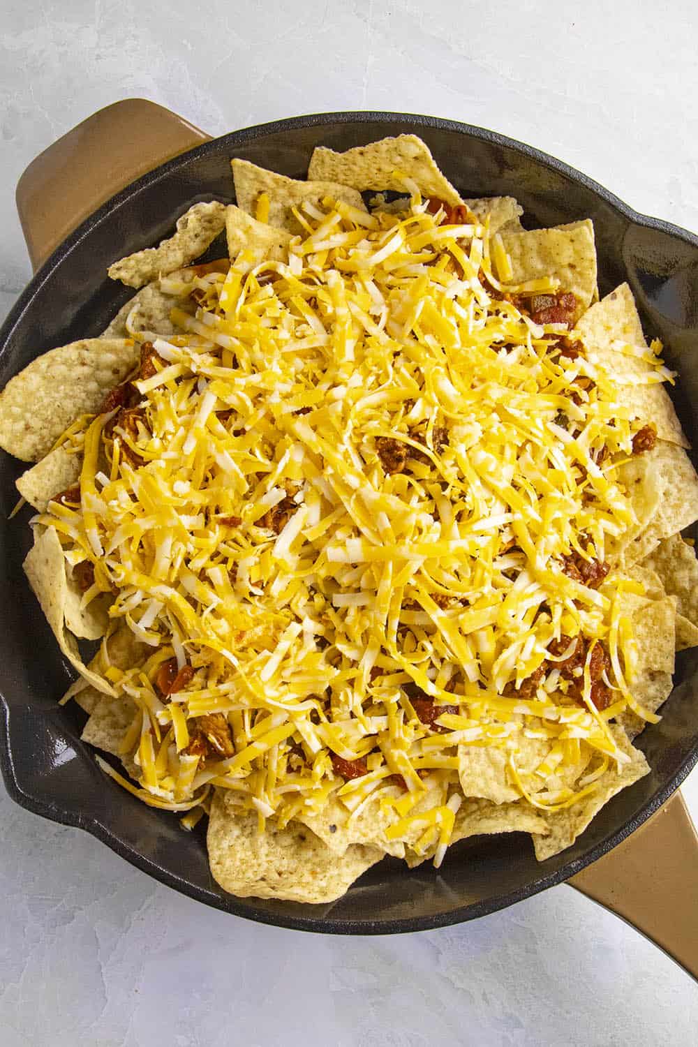 Add the shredded cheese over the Chipotle Chicken Nachos