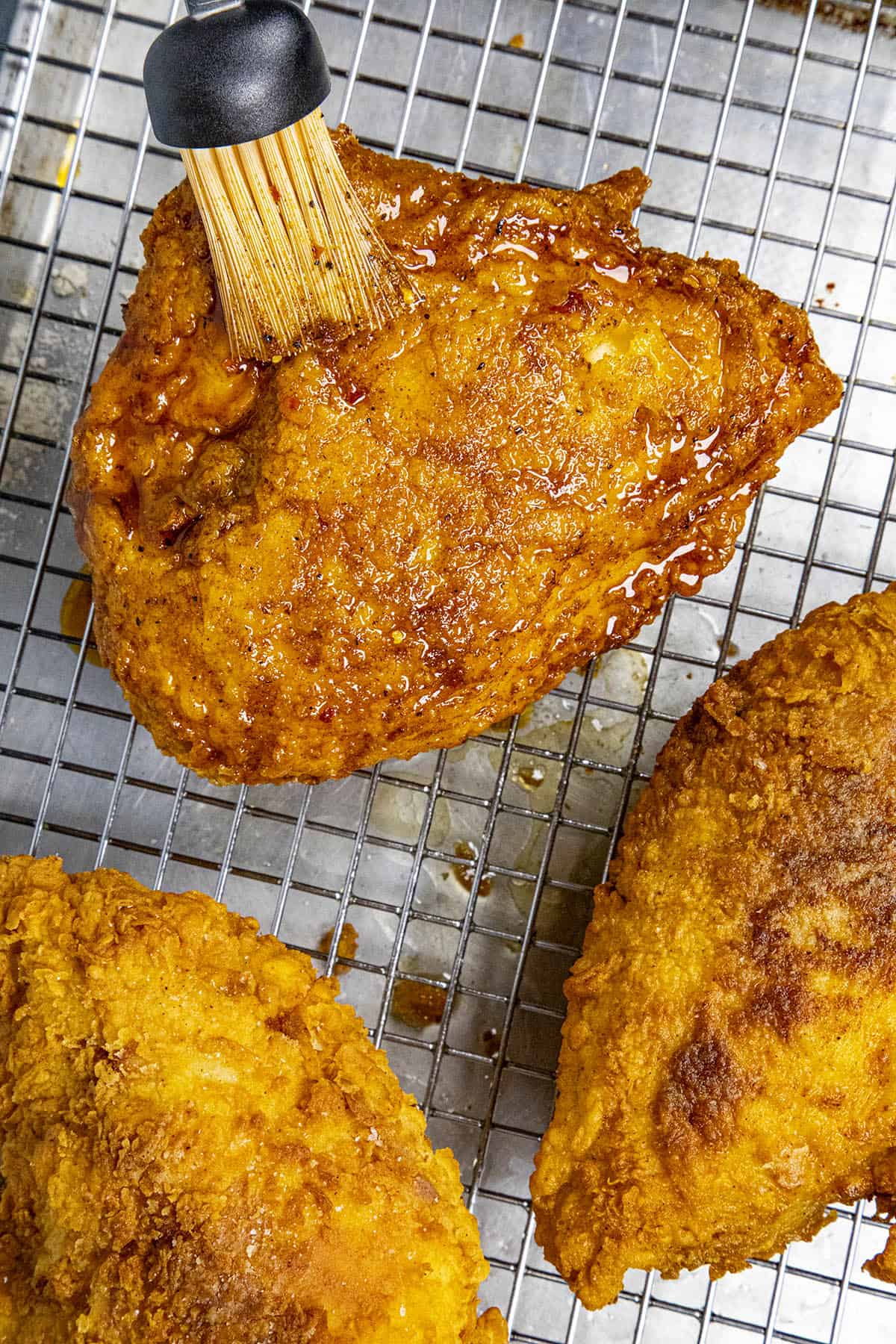 Step 6: Brushing the fried chicken with our hot oil mixture