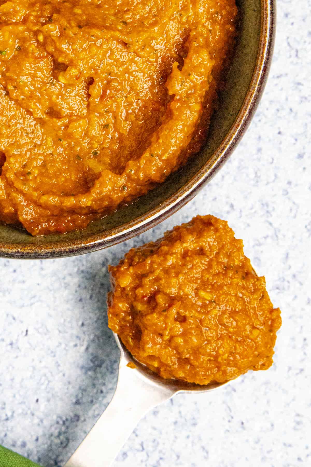 A large spoonful of Thai Red Curry Paste, ready for cooking