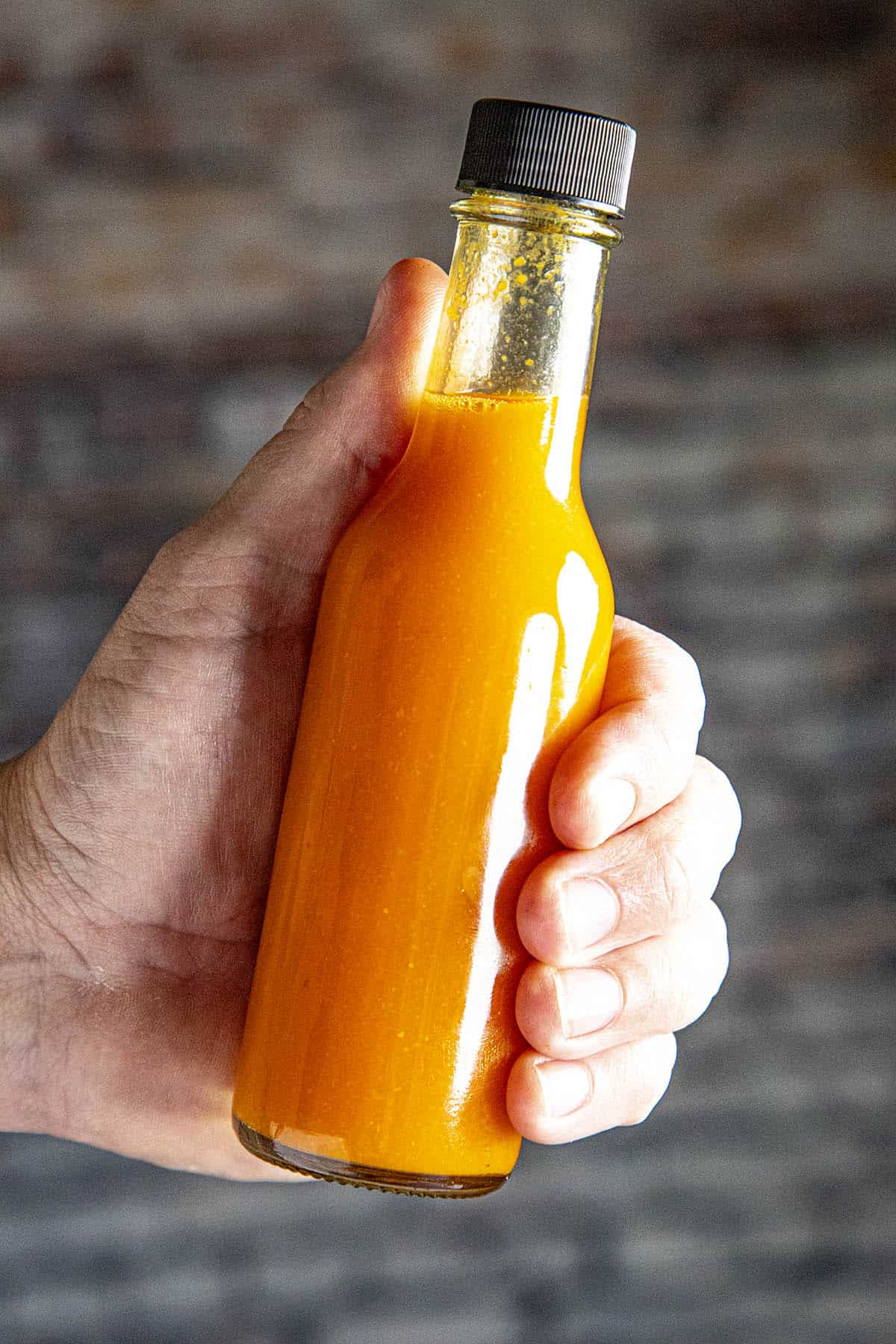 Holding a bottle of Homemade Tabasco Sauce