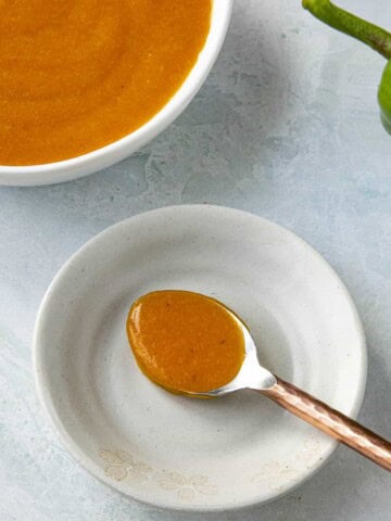 Aji Chili Sauce served in a bowl with a spoon on the side