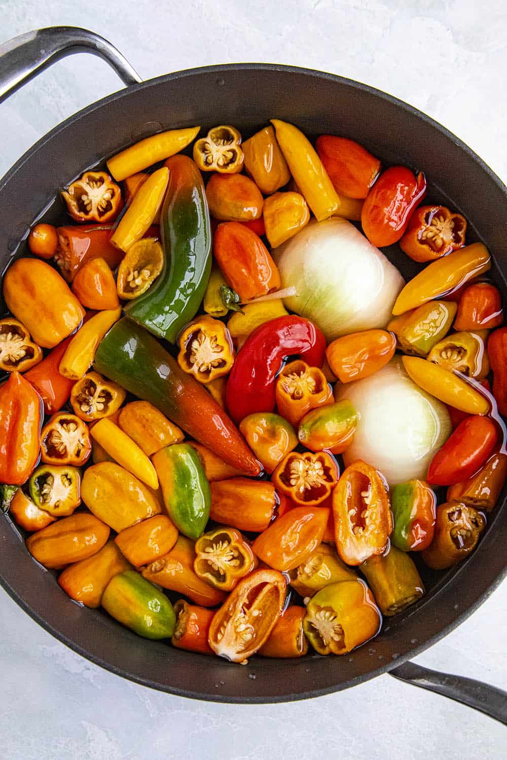 Boiling peppers and onions to make chili sauce