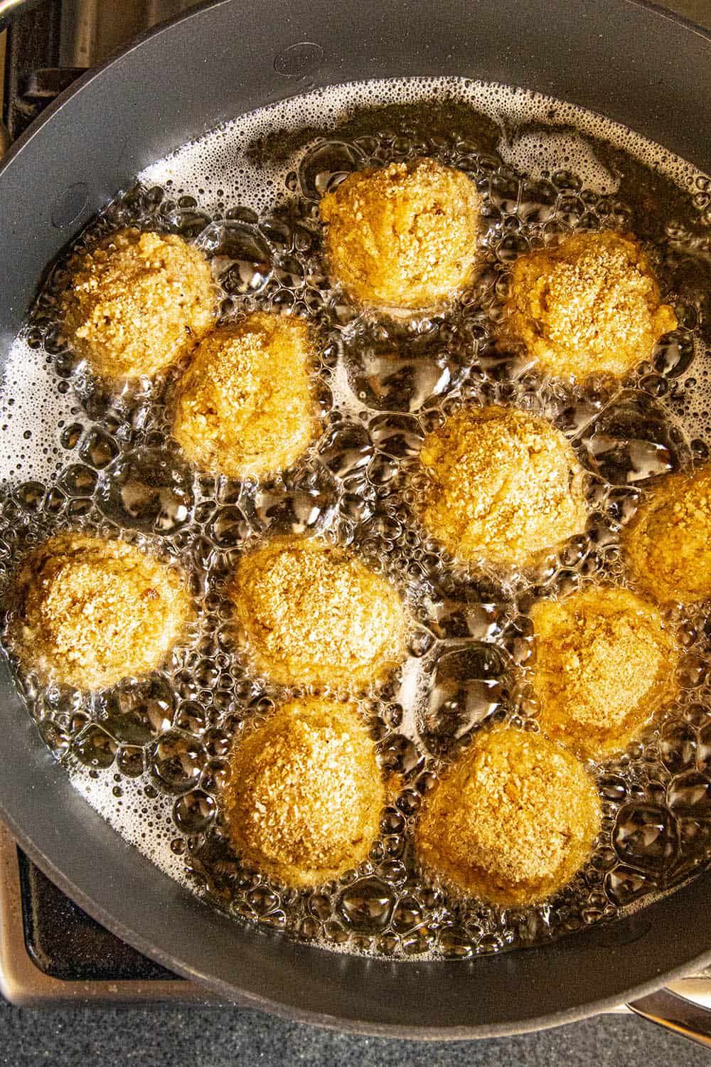 Boudin balls frying in a pan