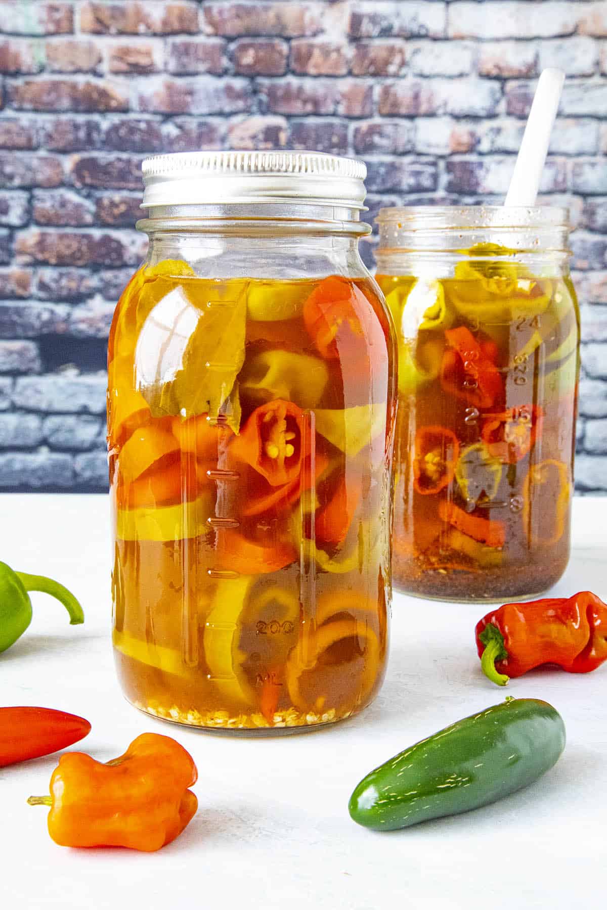 Spicy pickled peppers with Cajun seasoning in 2 jars