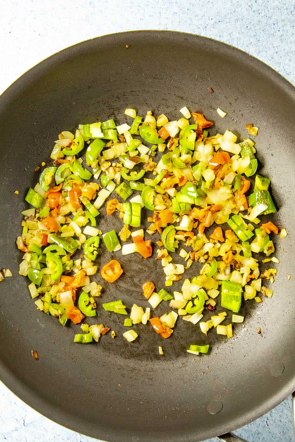 Cooking down the peppers and onion for making cashew chicken