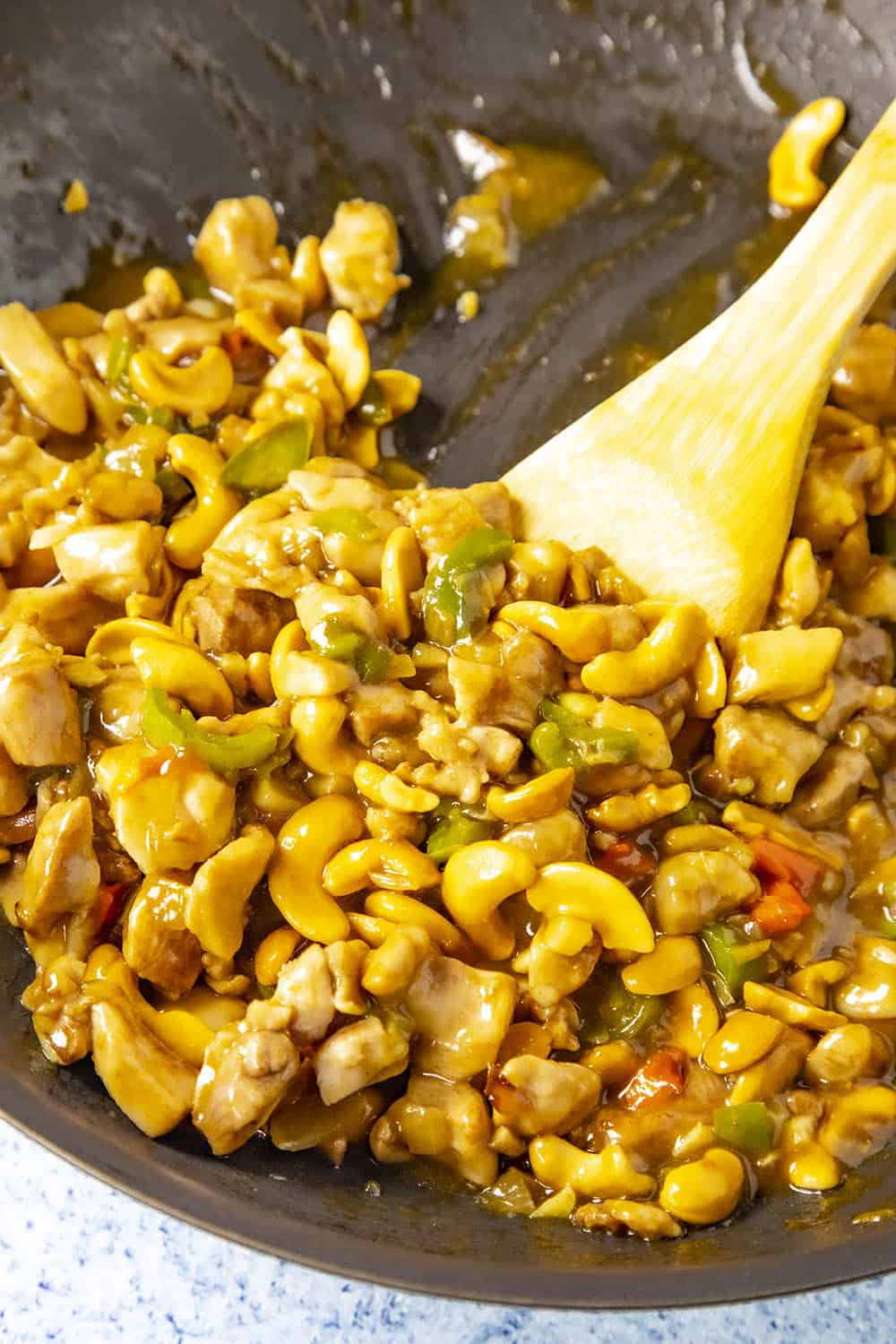 Stirring up the cashew chicken in a pan