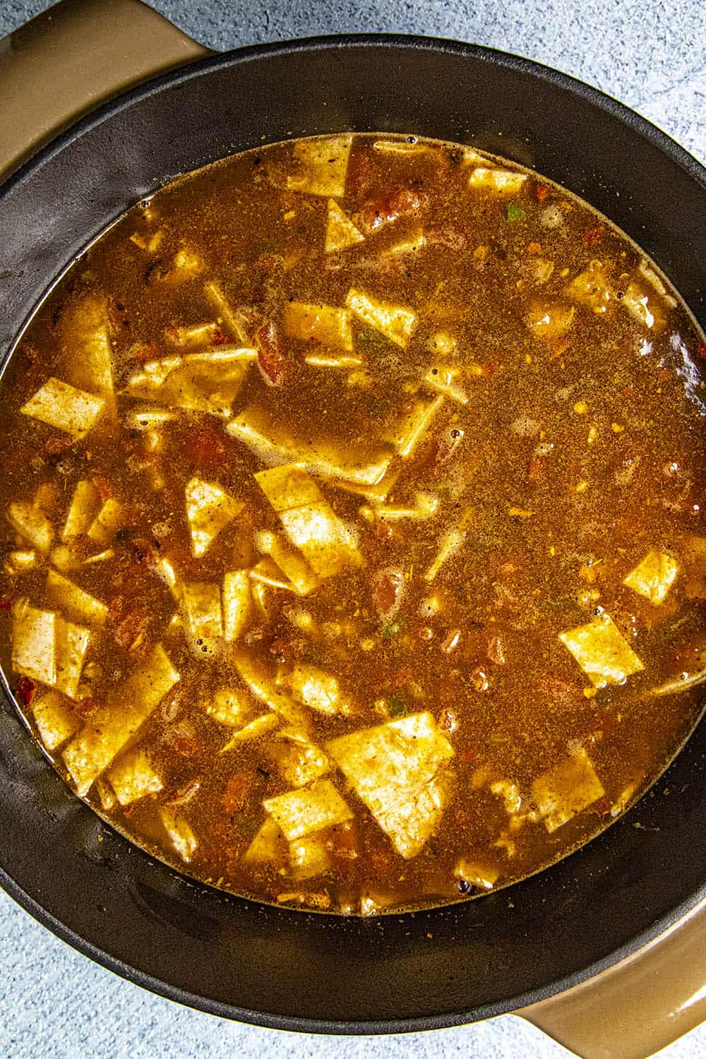 Adding fresh corn tortillas to thicken the chicken tortilla soup